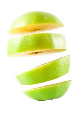 Green apple sliced over white background, studio
